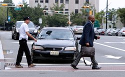 Pedestrians crossing street in crosswalk