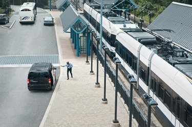 Via minivan picks up passenger at light rail station