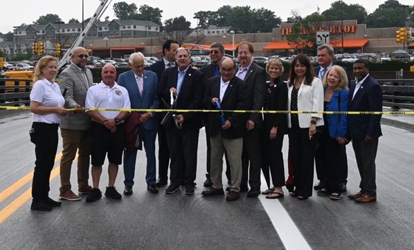 Local officials cut a ribbon to celebrate the reopening of a bridge