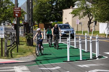 A child and two adults ride bicycles in a temporary bicycle lane that was constructed near the Henry Hudson Trail in Keyport.