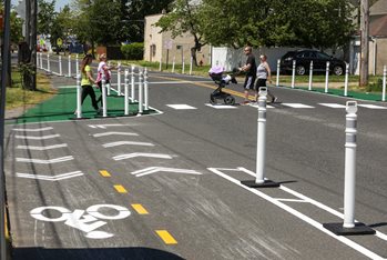 A group of a people walks on a temporary crosswalk that was created as part of a demonstration project in Keyport to improve access to the Henry Hudson Trail.